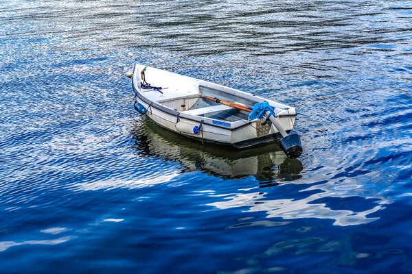 Colorful White Rowboat Blue Water Reflection Abstract Background Patterns Harbor  Dartmouth Devon England. 