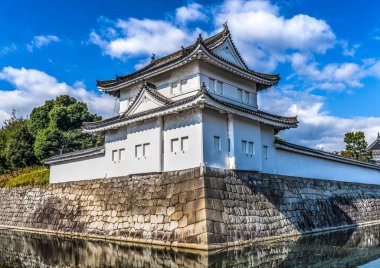 Colorful Outer Wall Tower Moat Reflection City Street Nijo Castle Kyoto Japan. Completed in 1626 by Tokugawa Shoguns. In 1867 Castle returned to Emperor.  clipart