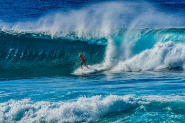Renkli Sörfçü Yeşil Oda Büyük Dalga Banzai Boru Hattı Kuzey Sahil Oahu Hawaii. Sığ resifin üzerindeki dev dalgalar, sörfçülerin binebileceği büyük, içi boş su kıvrımları oluşturur. Sığ resif sörf yapmak için tehlikeli ve güzel bir yer yaratır..