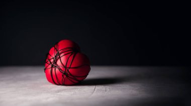 Painful, Sadness, Lack of freedom Concept. very Heartbreak and Sorrow. Messy Copper Wire Tied to a Red Heart so Tight. Dark tone