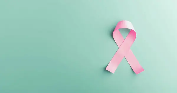 Breast Cancer Awareness Campaign Concept. Women Healthcare. Close up of a Pink Ribbon Lying on light blue background, Top View
