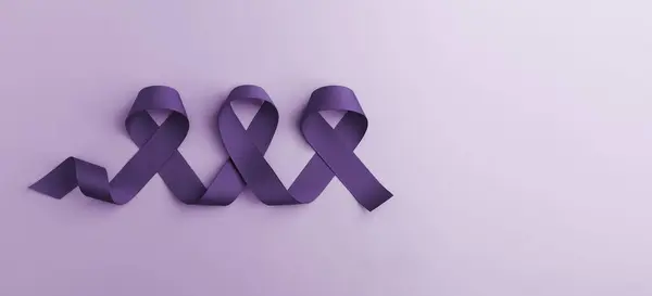 Cancer Awareness Concept. Global Community in Healthcare. World Cancer Day. Close up of Violet Ribbon. Top View