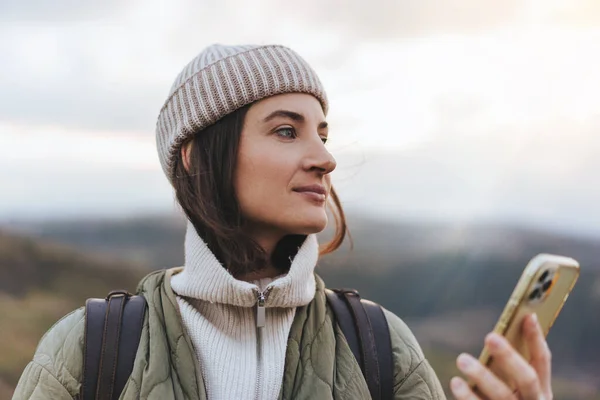 stock image Portrait of woman traveller using online map in mobile phone while hiking in the forest, female hands holding modern cell telephone gadget