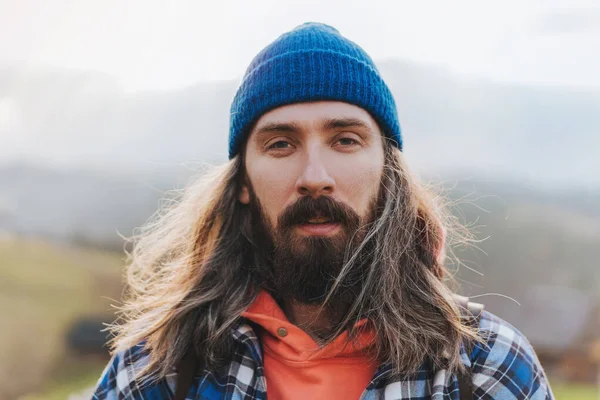 Portrait Attractive Man Long Hair Wearing Blue Hat Jacket Mountain Stock Image