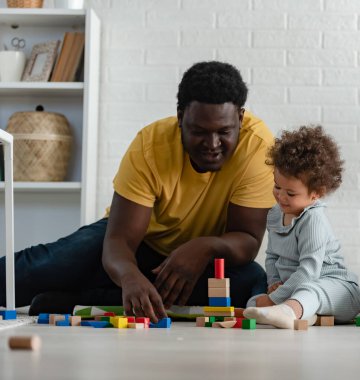 father and daughter playing with constructor