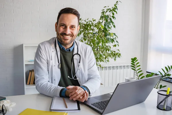 handsome young doctor consulting patients online