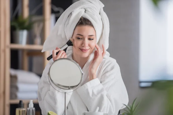 stock image young beautiful woman doing her make up