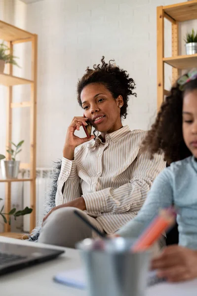 stock image african american mother working at home with her daughter