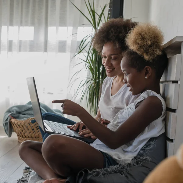 stock image african american mother and daughter using laptop