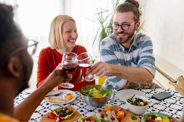 happy friends having dinner together