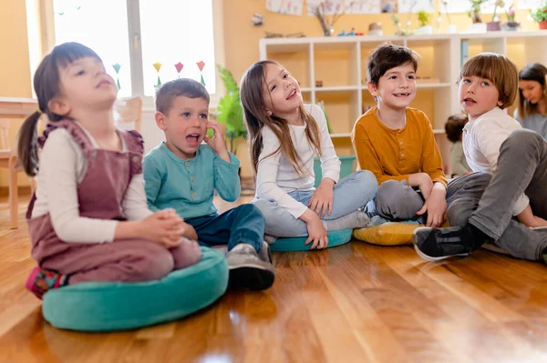 Aktif anaokulu çocukları öğretmenleriyle etkileşim halindeler. Öğretmen-çocuk ilişkileri erken öğrenme. Sağlıklı Öğrenme Ortamı