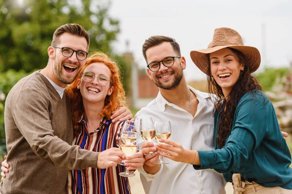 stock image happy friends drinking wine at vineyard