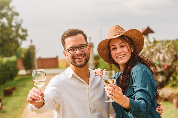 年轻貌美的夫妻在葡萄园品酒 与年轻人享受收获时光的友谊与爱的概念 — 图库照片