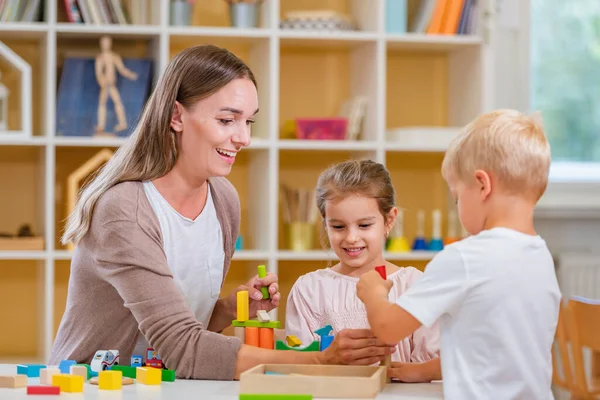 Kindergarten Teacher Playing Together Children Colorful Preschool Classroom Mother Playing — Stock Photo, Image