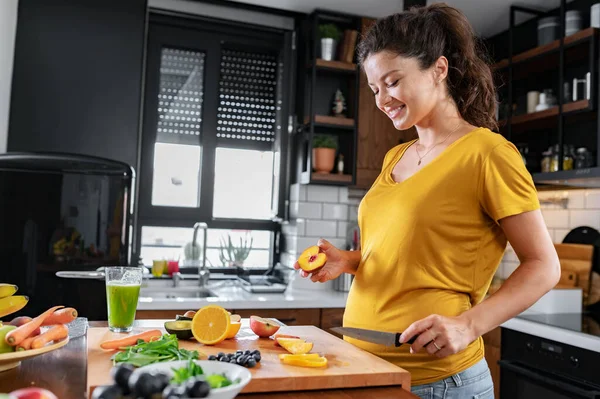 stock image pregnant woman cooking at kitchen, healthy eating concept