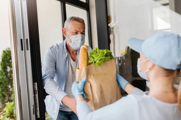 Delivery Service Girl Brings Groceries Elderly Man Covid Pandemic Peole — Stock Photo, Image