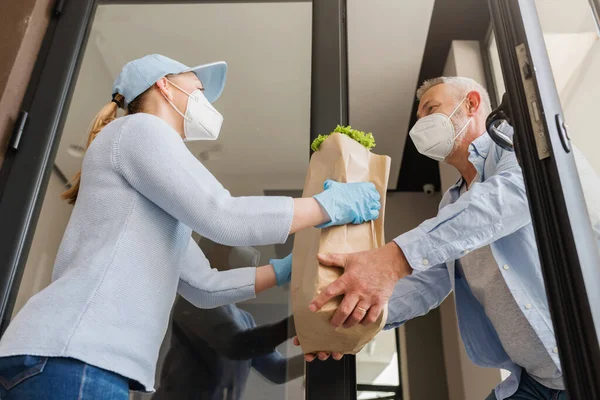 Delivery Service Girl Brings Groceries Elderly Man Covid Pandemic Peole — Stock Photo, Image