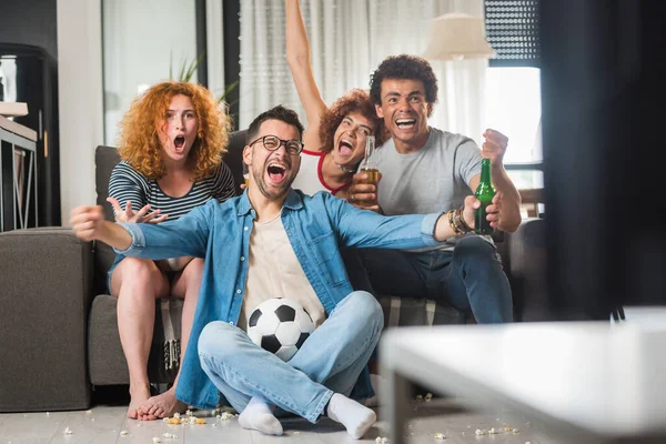 stock image group of friends watching football, drinking beer