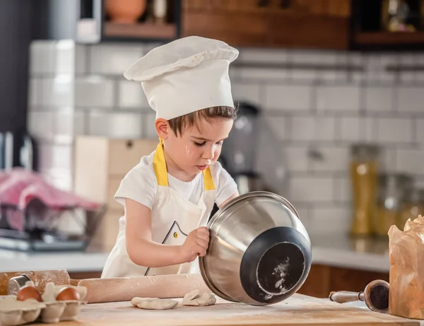 Stock image cute little boy cooking cookies in kitchen