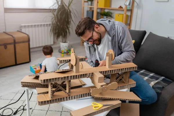 stock image father making wooden plane for his son