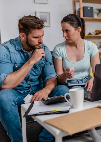 stock image young couple counting bills