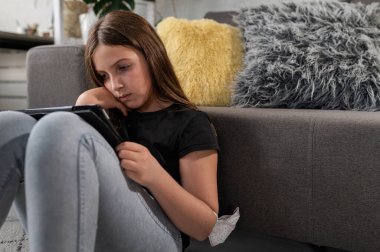 Tablet kullanan sevimli küçük kız.