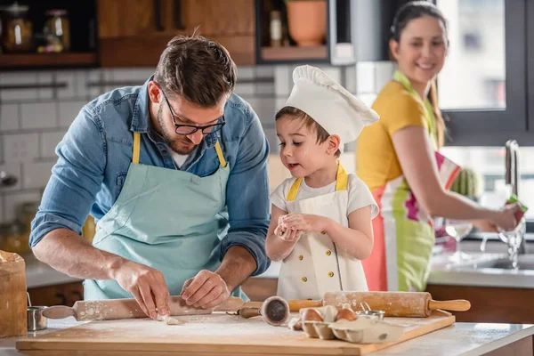 family cooking together, mother, father and son