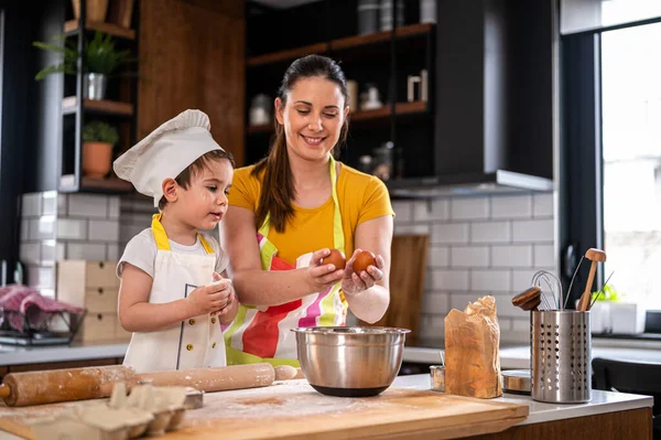 stock image mother cooking with son. working with dough