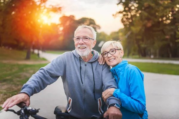 happy senior couple riding bike