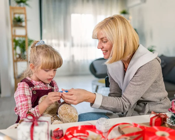 Mother Daughter Preparing Holidays Wrapping Gifts Stock Photo