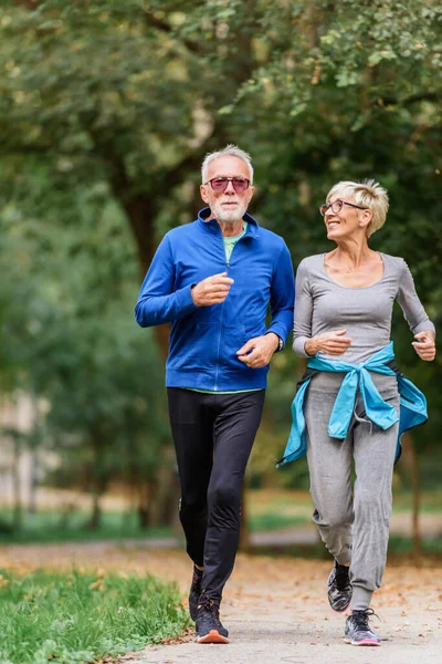 senior couple jogging in the park