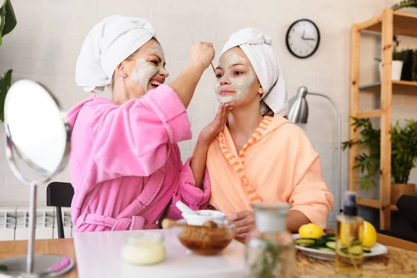 stock image beautiful mother and daughter making skin treatment