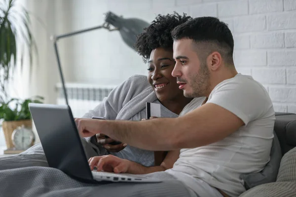 Smiling Mixed Race Couple Lying Bed Laptop Bedroom Home — Stock Photo, Image