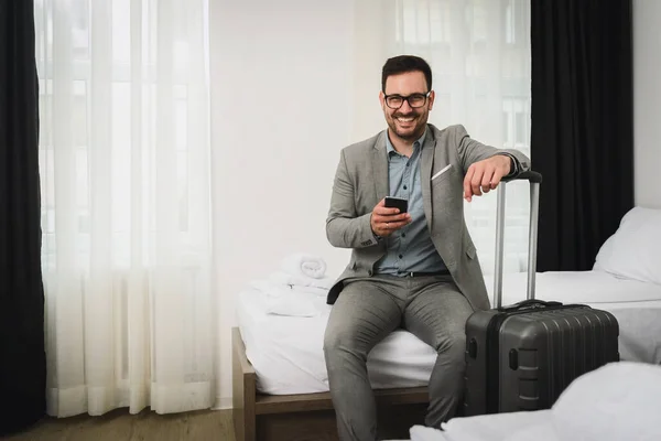 man with luggage waiting for business trip