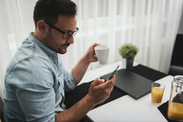 Stock image handsome young man with cup of coffee at home