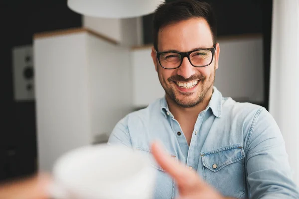 stock image handsome young man with cup of coffee at home