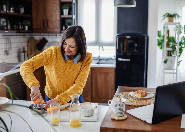 stock image woman working at home in a kitchen 