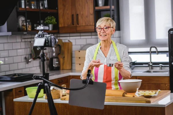 senior woman food blogger filming recipe