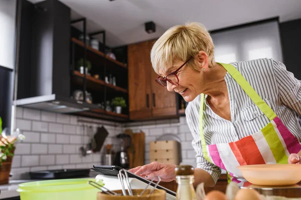 woman using tablet in kitchen