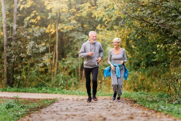 stock image senior couple jogging in the park 