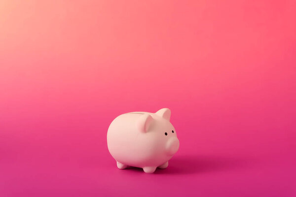 White piggy bank on rose magenta color background. Saving, money accumulation, investment, banking or business services, wealth concept.