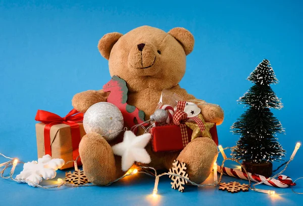 Cute Teddy Bear with Christmas holiday symbols. Holiday New Year background