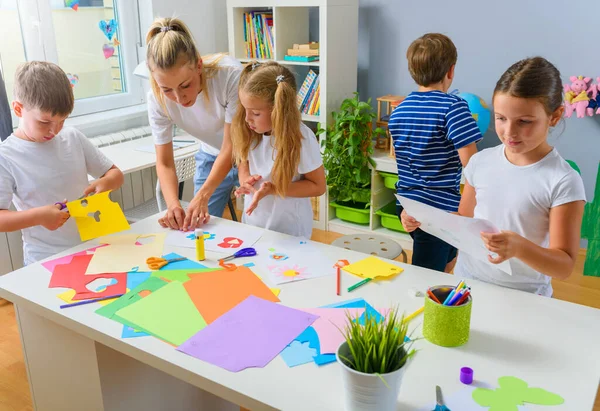 stock image students making paper handicrafts with teacher