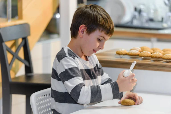 stock image cute little boy decorating cookies with icing