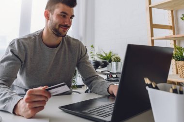 Kredi kartı tutan adam, online alışveriş konsepti