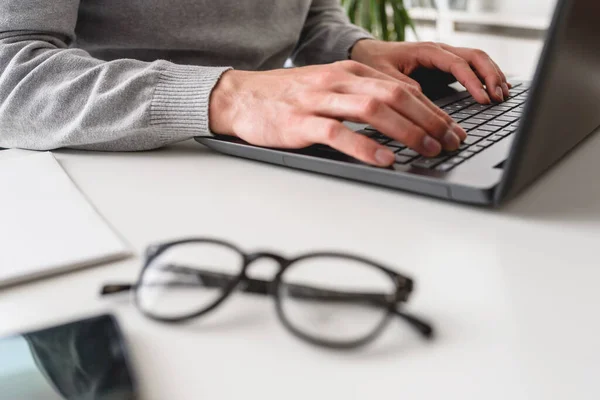 Stock image view of businessman using laptop,typing in office