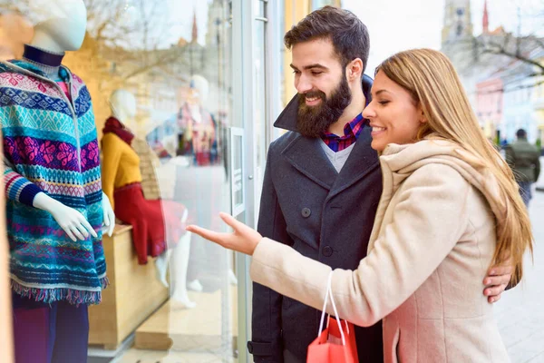 stock image Beautiful young loving couple carrying bags and enjoying together holiday shopping