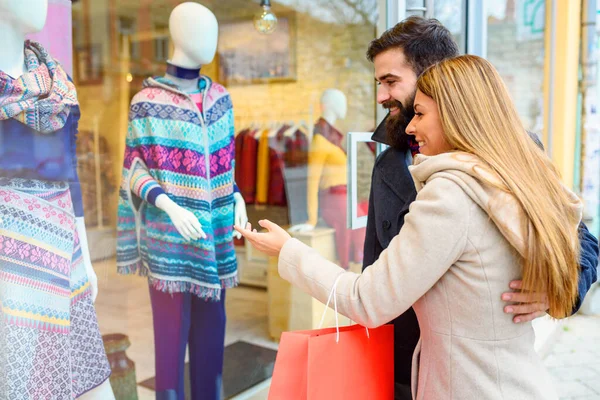 stock image Beautiful young loving couple carrying bags and enjoying together holiday shopping