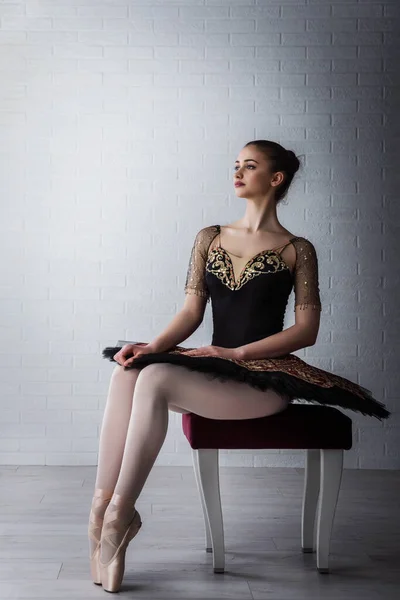 年轻美丽的完美芭蕾舞演员坐在室内椅子上的画像 — 图库照片