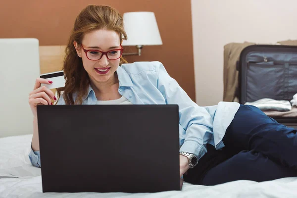 stock image young beautiful woman with credit card making order in online store